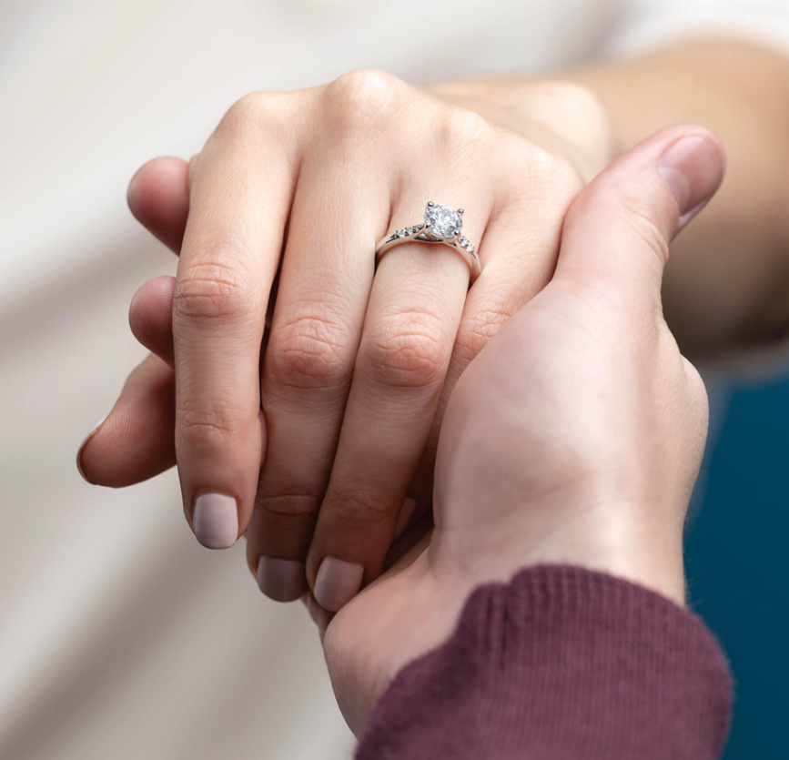A wedding ring on a woman's finger.